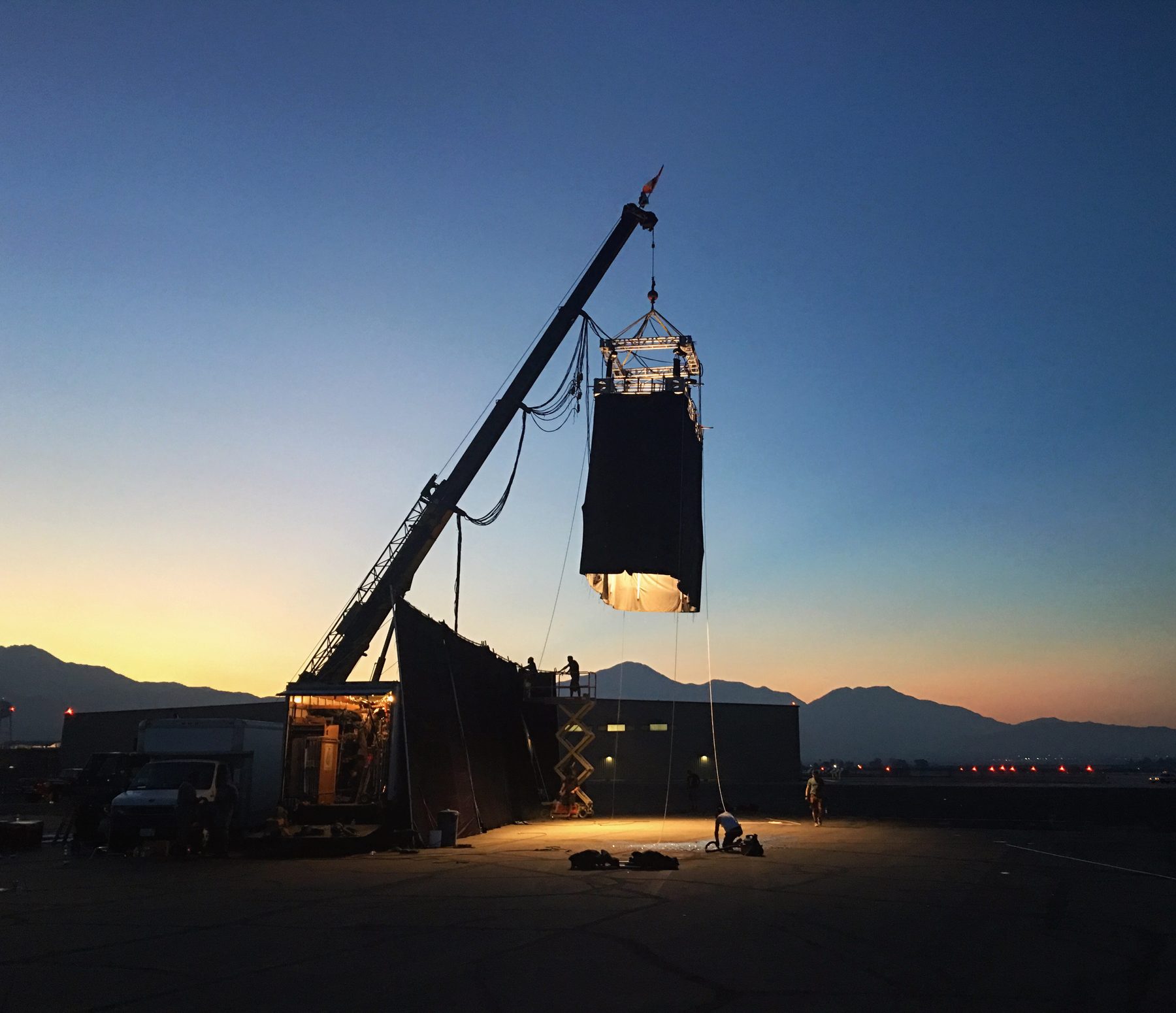 Crane-rigged solid at dusk on location